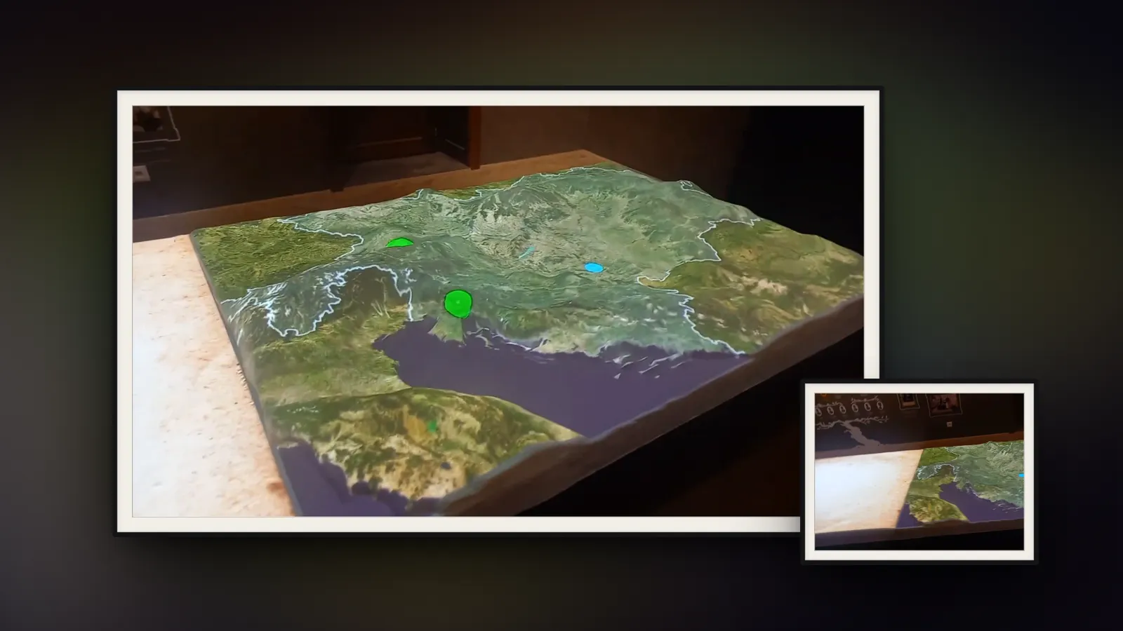 The Austria-Hungary relief in two framed photographs: satellite terrain projected onto the physical model in a dark room, with points of interest lit up.