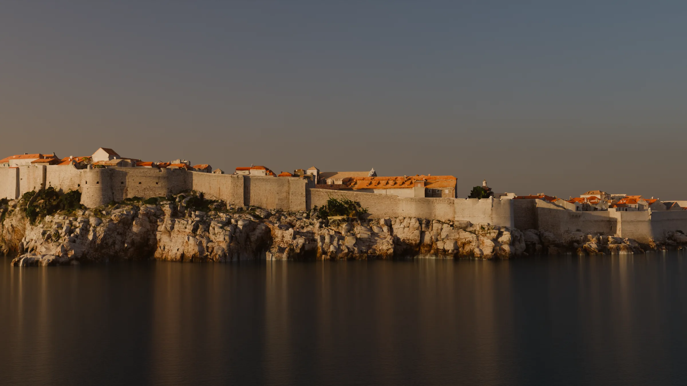 The southern City Walls on their sea cliffs, lit by a low evening sun, rendered from the photogrammetry model